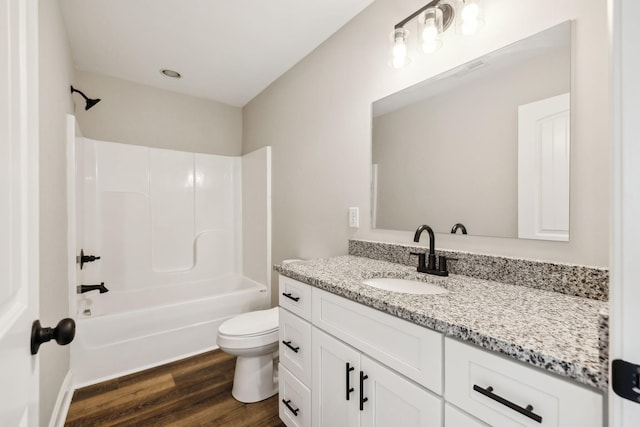 full bathroom featuring bathtub / shower combination, vanity, toilet, and hardwood / wood-style floors