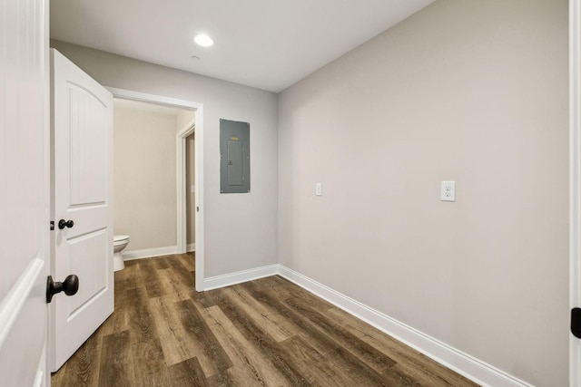 corridor with electric panel and dark hardwood / wood-style floors