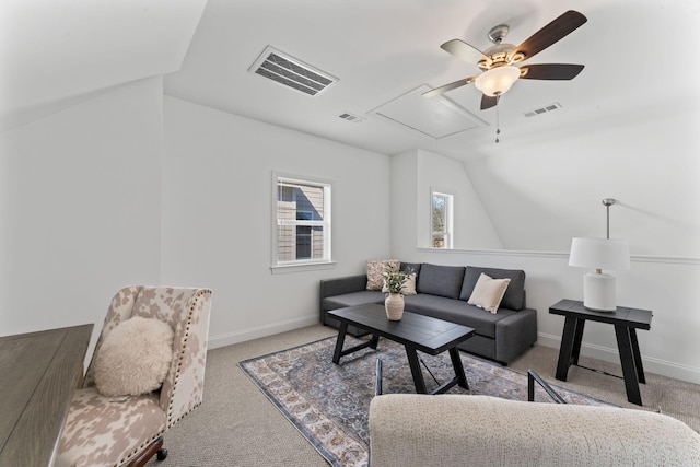 carpeted living room with ceiling fan and vaulted ceiling