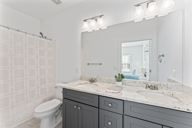 bathroom with tile patterned flooring, vanity, a shower with shower curtain, and toilet