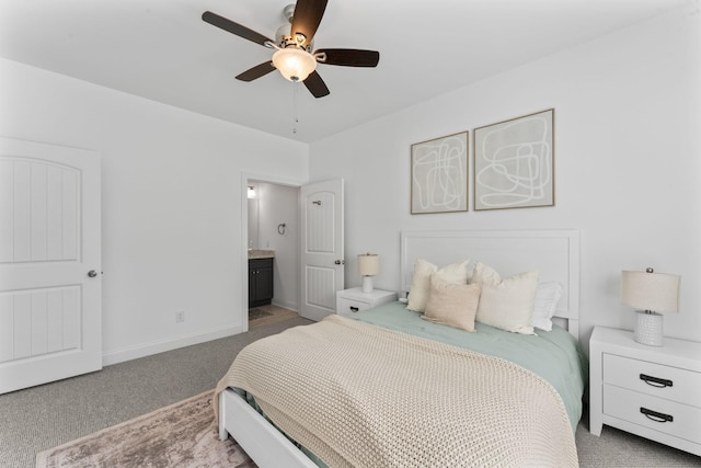 carpeted bedroom featuring ceiling fan and ensuite bath