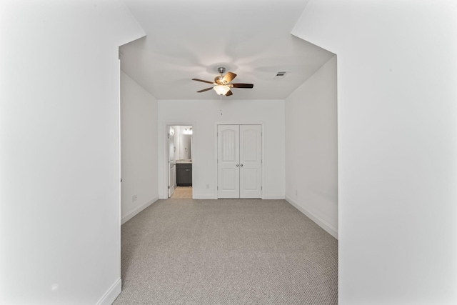 carpeted empty room featuring ceiling fan