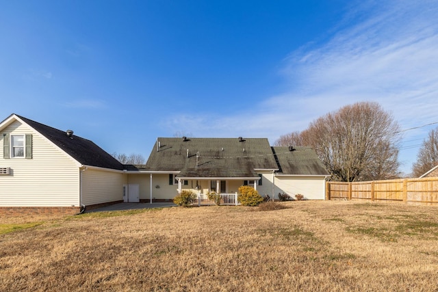 rear view of house featuring a lawn