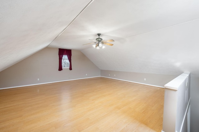 bonus room featuring light hardwood / wood-style flooring, ceiling fan, and vaulted ceiling