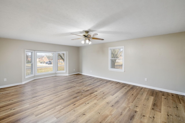 spare room featuring ceiling fan and light wood-type flooring