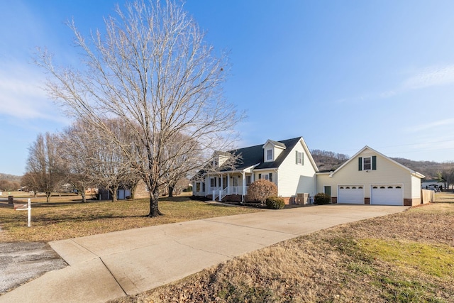 view of front of house featuring a garage, a front yard, and covered porch