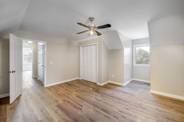 bonus room with vaulted ceiling, ceiling fan, and light wood-type flooring