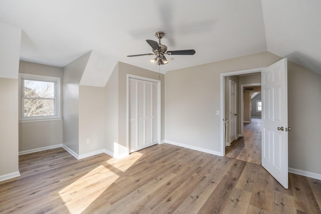 additional living space with vaulted ceiling, ceiling fan, and light wood-type flooring