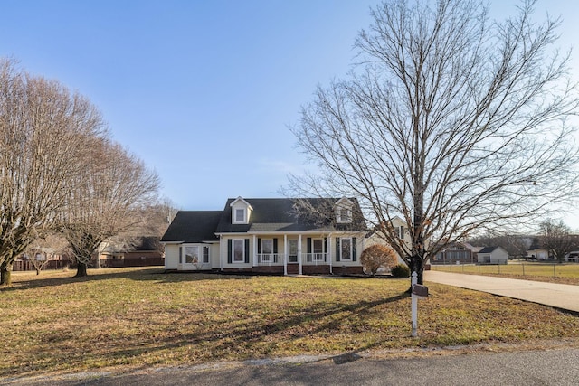 cape cod-style house with a porch and a front yard