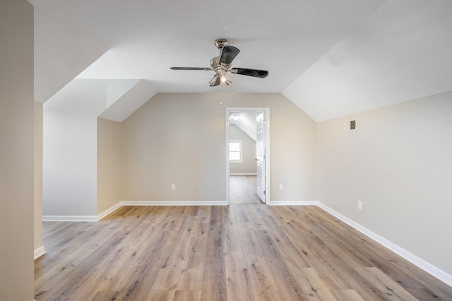 additional living space featuring lofted ceiling, light hardwood / wood-style flooring, and ceiling fan