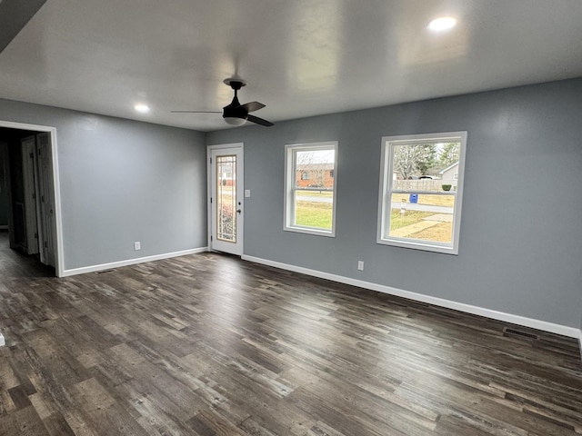 empty room with ceiling fan and dark hardwood / wood-style floors