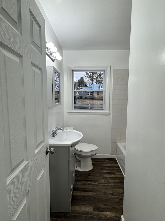 bathroom with vanity, hardwood / wood-style floors, and toilet