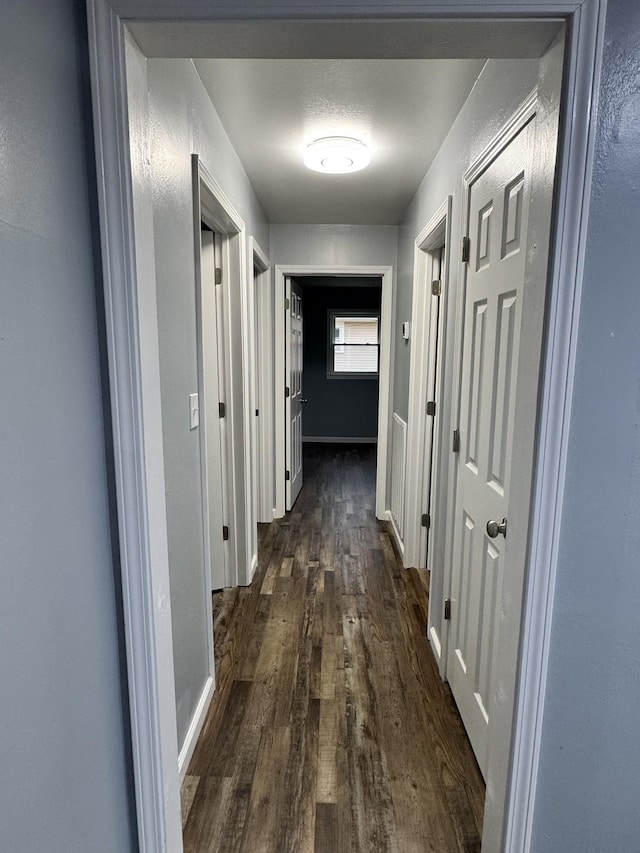 hall with dark hardwood / wood-style floors