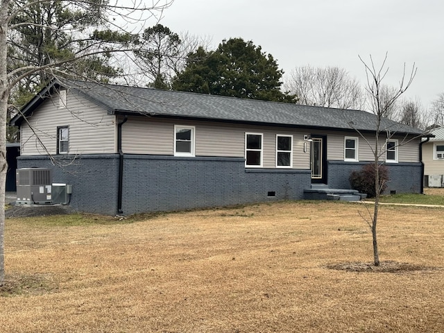 view of front of property with cooling unit and a front lawn