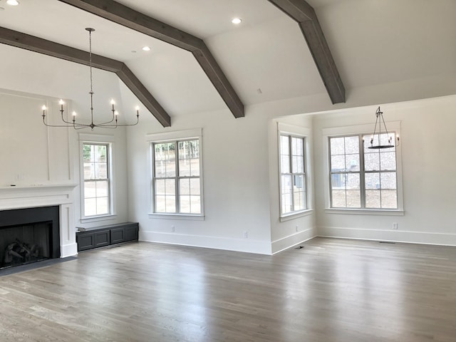 unfurnished living room with dark hardwood / wood-style floors, a chandelier, and lofted ceiling with beams