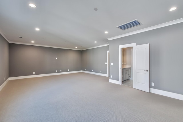 unfurnished room featuring crown molding and light colored carpet