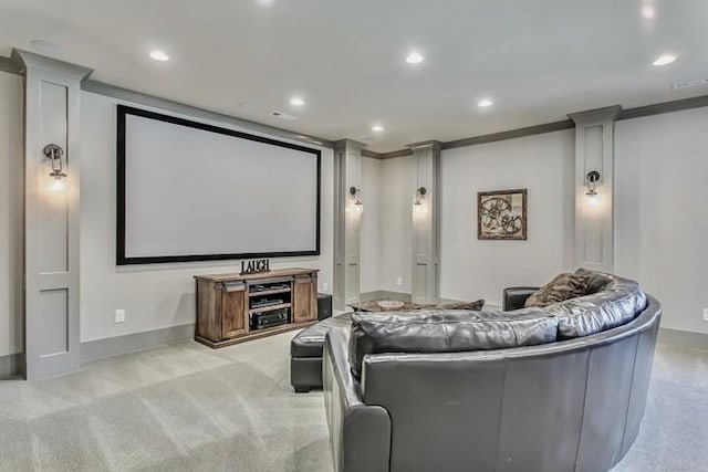 carpeted home theater featuring crown molding