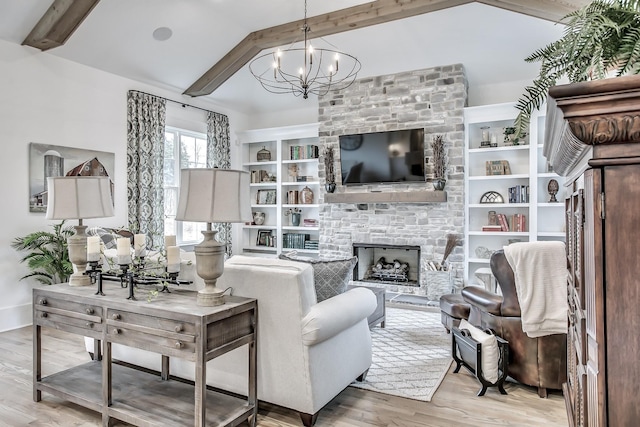 living room featuring a stone fireplace, beam ceiling, and light hardwood / wood-style flooring