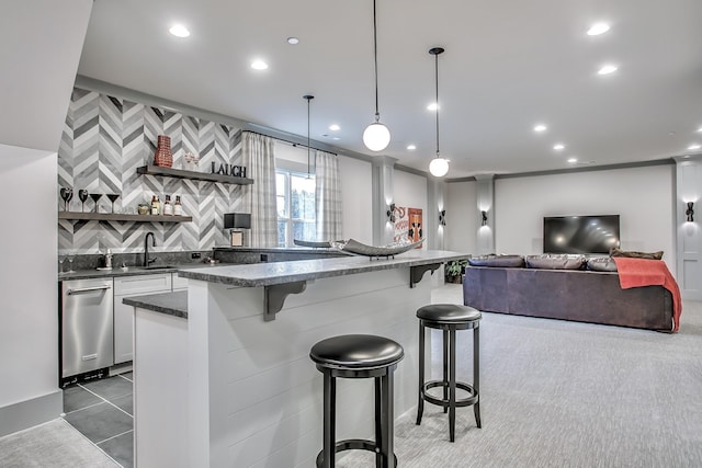 kitchen featuring light tile patterned floors, backsplash, a kitchen breakfast bar, white cabinets, and decorative light fixtures