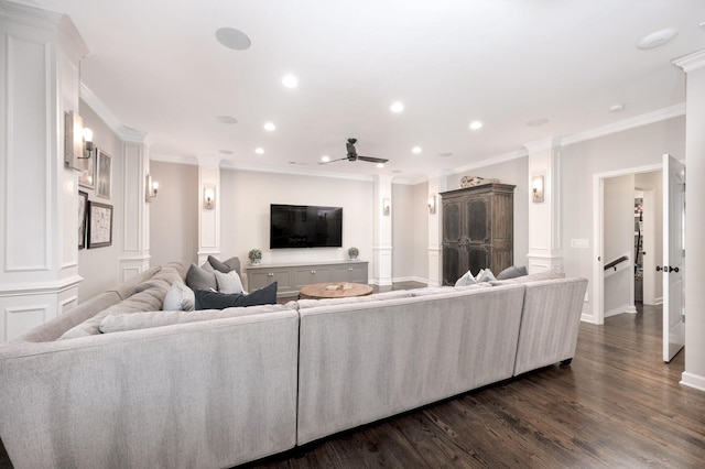 living room with crown molding, ceiling fan, dark hardwood / wood-style flooring, and decorative columns