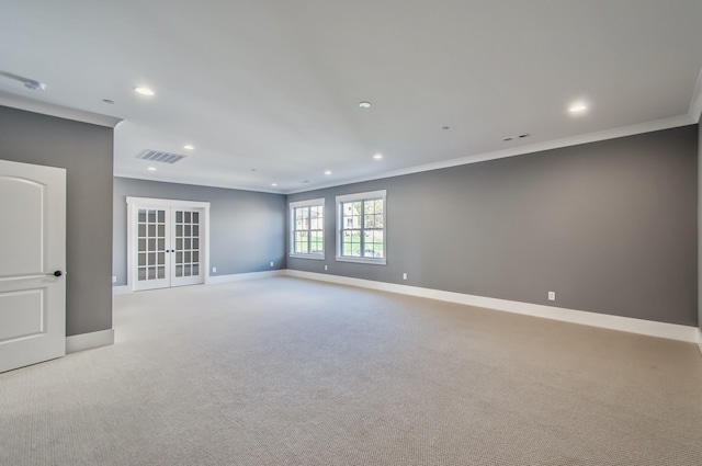 carpeted empty room featuring ornamental molding and french doors