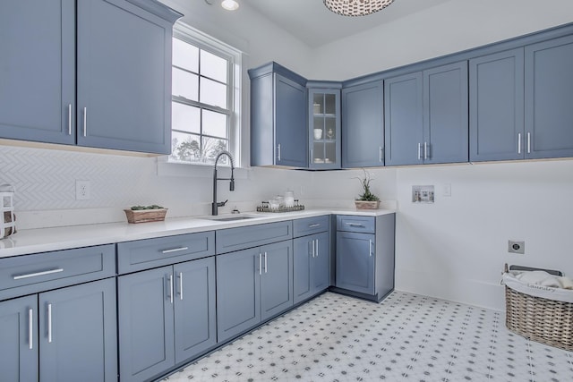 washroom with electric dryer hookup, sink, and cabinets