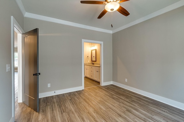 unfurnished bedroom with crown molding, ceiling fan, connected bathroom, and light hardwood / wood-style flooring