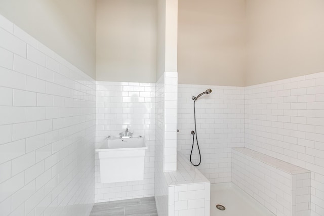 bathroom with plus walk in shower and tile walls