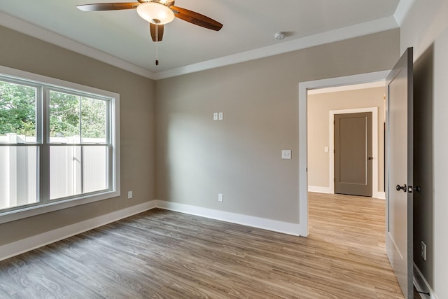 empty room with ornamental molding, light hardwood / wood-style floors, and ceiling fan