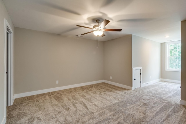 unfurnished room with ceiling fan and light carpet