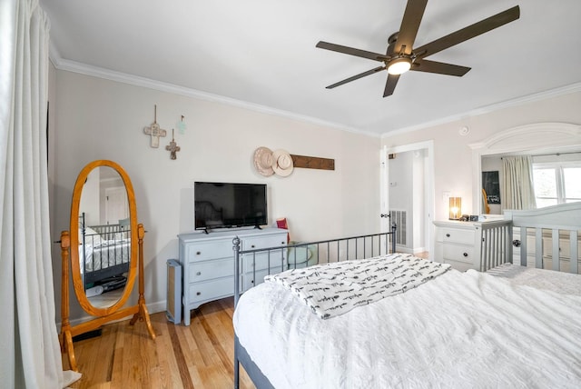 bedroom featuring ornamental molding, ceiling fan, and light hardwood / wood-style flooring