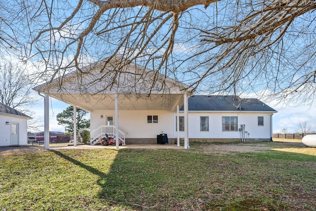 rear view of house featuring a lawn