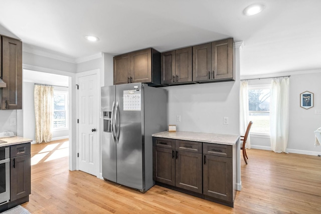 kitchen with crown molding, stainless steel fridge, dark brown cabinets, and light hardwood / wood-style flooring