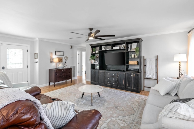 living room with crown molding, ceiling fan, and light hardwood / wood-style flooring