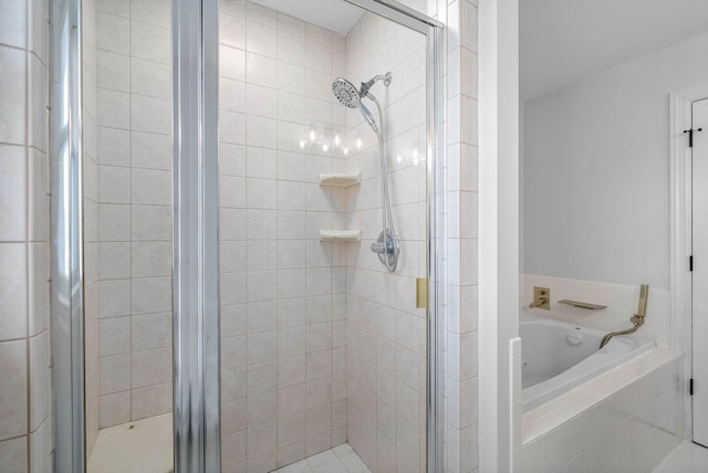 bathroom featuring shower with separate bathtub