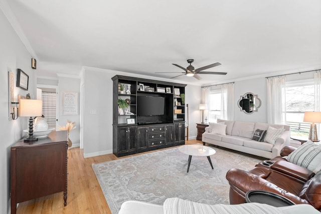 living room featuring ornamental molding, ceiling fan, and light hardwood / wood-style floors