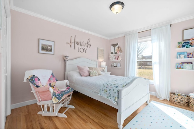 bedroom with hardwood / wood-style floors and ornamental molding