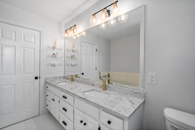 bathroom featuring tile patterned floors, vanity, and toilet