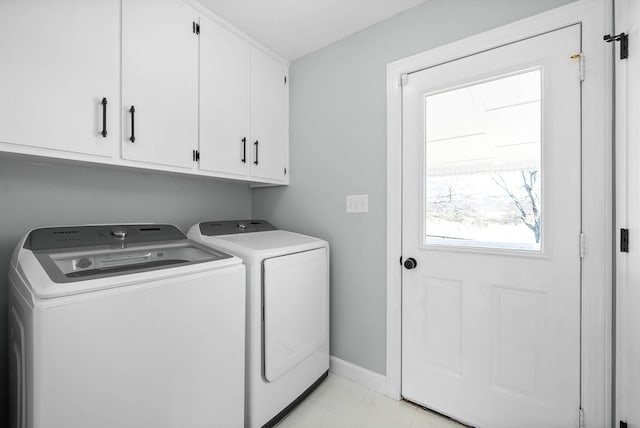 washroom with independent washer and dryer and cabinets