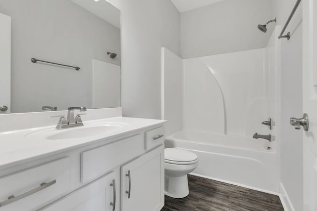 full bathroom with vanity, hardwood / wood-style floors,  shower combination, and toilet