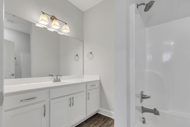 bathroom with  shower combination, wood-type flooring, and vanity