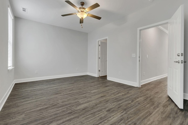 spare room featuring ceiling fan and dark hardwood / wood-style flooring