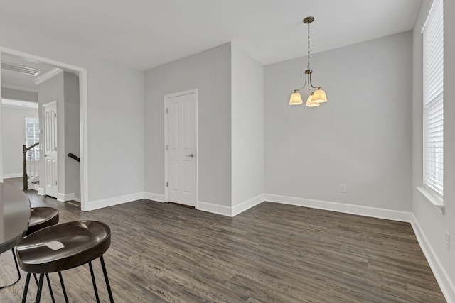 interior space featuring plenty of natural light, dark hardwood / wood-style floors, and a chandelier