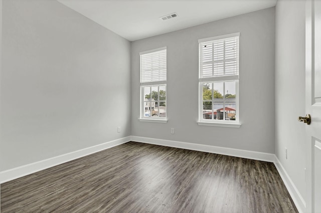 spare room with dark hardwood / wood-style floors