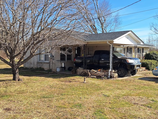 view of side of property with a carport and a yard