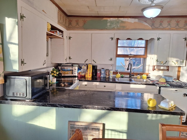 kitchen with crown molding, sink, white appliances, and white cabinets