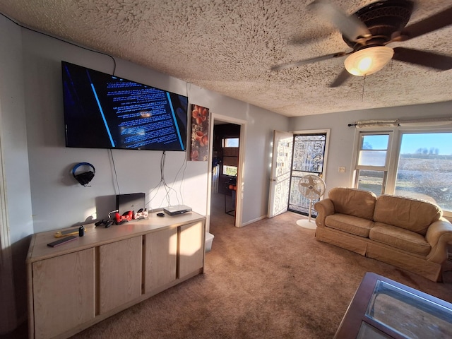 living room with ceiling fan, light colored carpet, and a textured ceiling