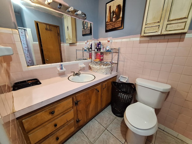 bathroom with tile patterned flooring, vanity, tile walls, and toilet