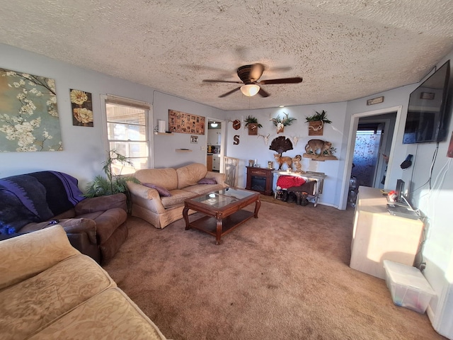 carpeted living room with ceiling fan and a textured ceiling