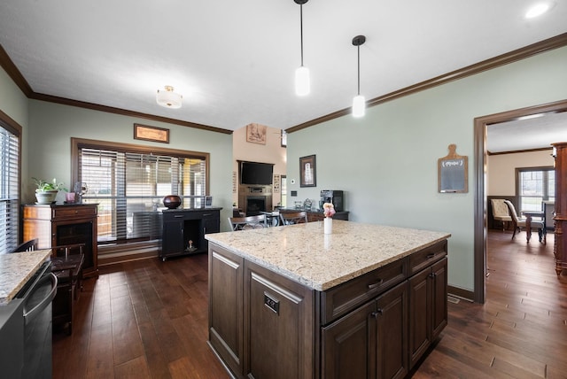 kitchen with decorative light fixtures, dark brown cabinets, dark wood-type flooring, and a kitchen island